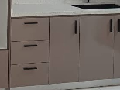 Soft-closing timber kitchen drawer with custom dish organizer by Orked Kitchen Cabinet
